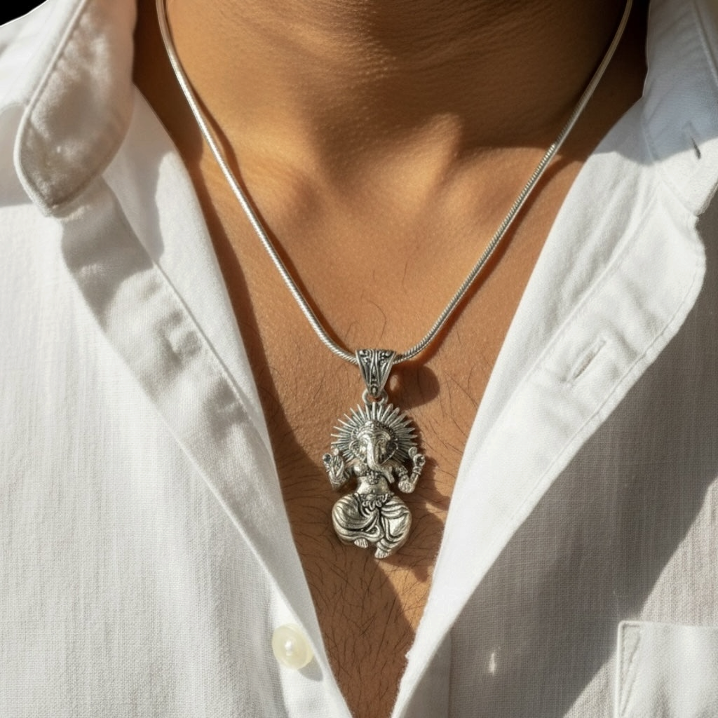 Myver oxidized silver Lord Ganesha pendant on a sleek chain worn against a white shirt for a spiritual aesthetic.