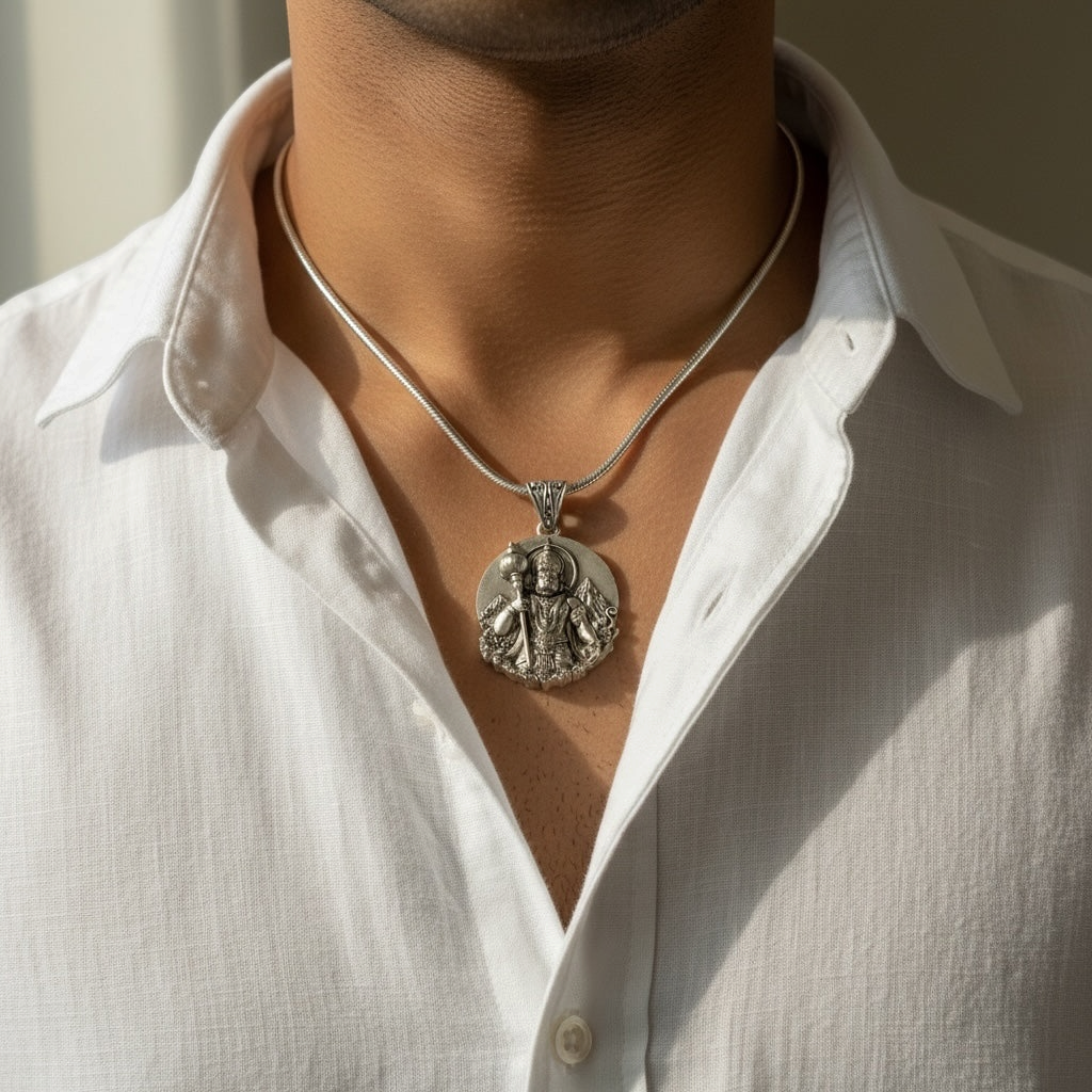 Myver silver Lord Hanuman round pendant necklace with 3D embossed Gada design worn by a man in a white shirt.