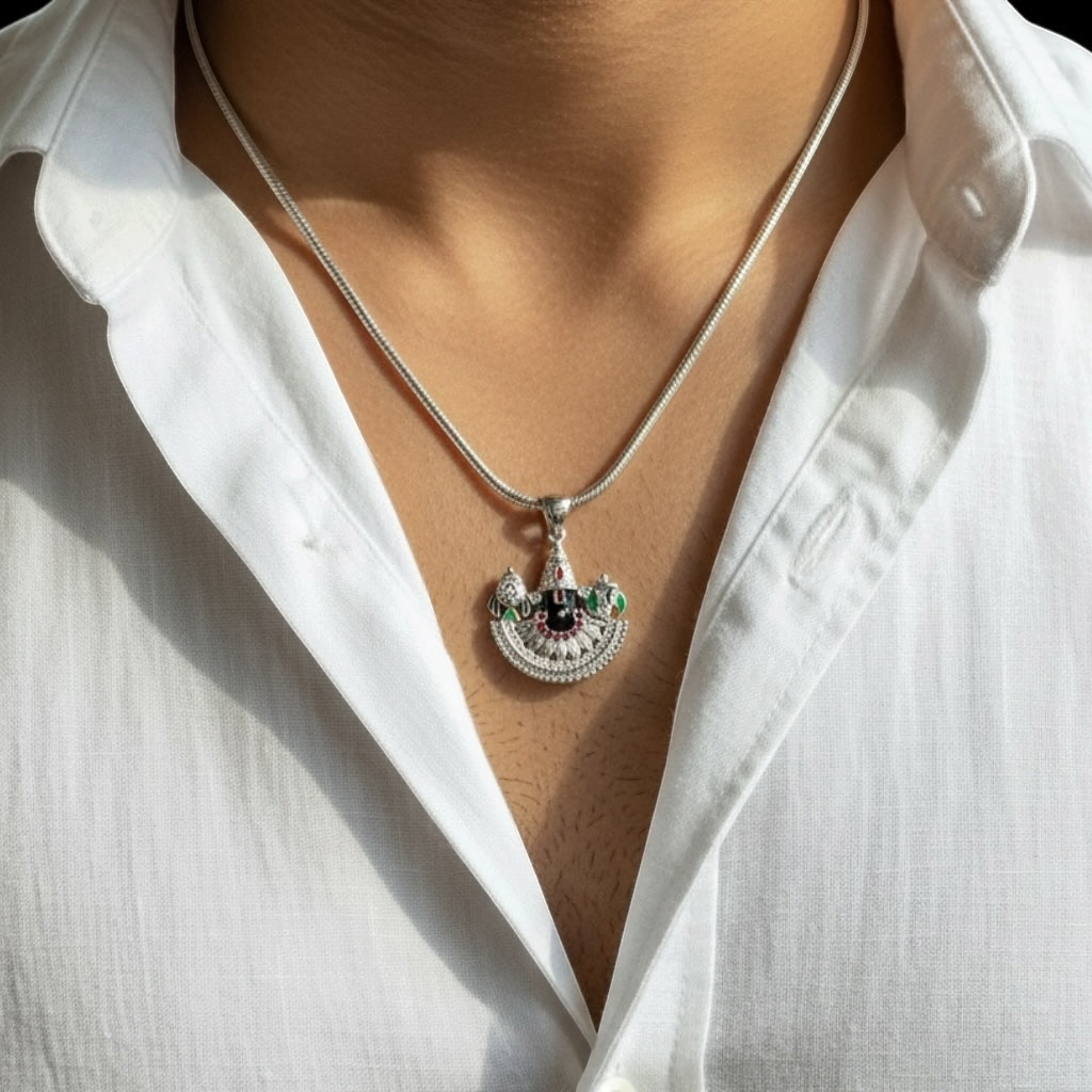 Myver silver-toned temple design pendant with red, green, and black accents worn on a sleek chain by a man.
